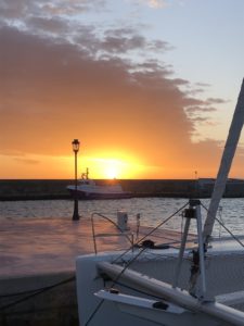 Sonnenuntergang mit Bug eines Bootes und Wellenbrecher